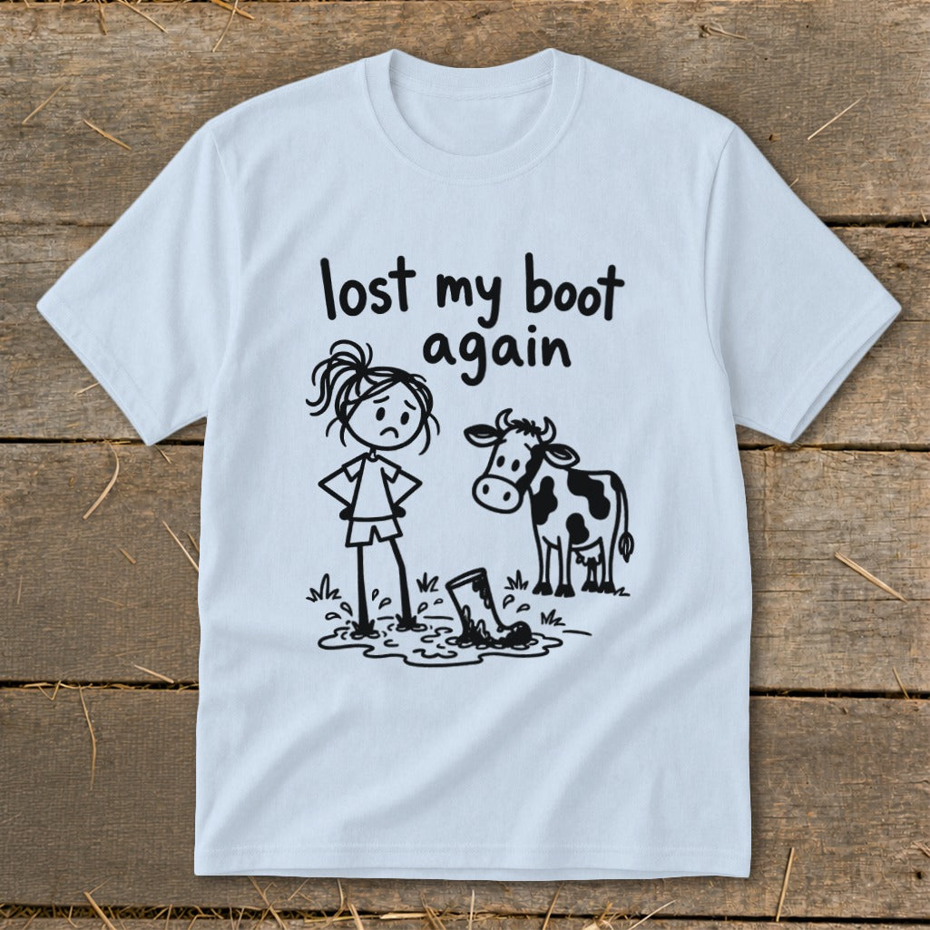 Light blue t-shirt featuring a cartoon of a girl and cow with the text lost my boot again.