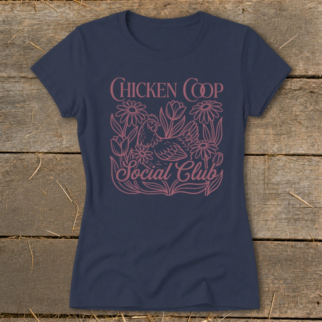 Navy t-shirt with pink graphic of a chicken, flowers, and text reading "CHICKEN COOP Social Club".