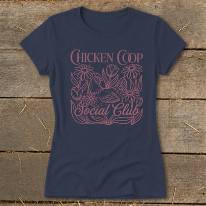 Navy t-shirt with pink graphic of a chicken, flowers, and text reading "CHICKEN COOP Social Club".