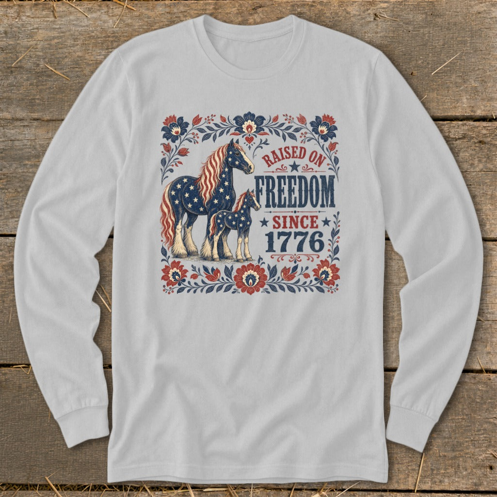 Long sleeve shirt with horses and the text "Raised on Freedom Since 1776".