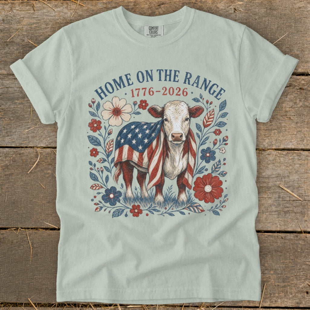 Cow wrapped in American flag with "Home on the Range 1776-2026" text.