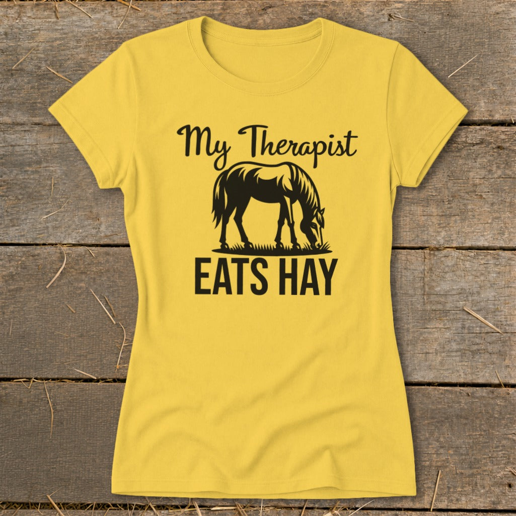 Yellow t-shirt with black text and horse graphic that reads "My Therapist EATS HAY".