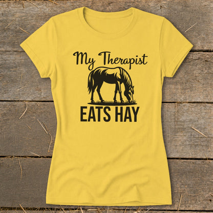 Yellow t-shirt with black text and horse graphic that reads "My Therapist EATS HAY".