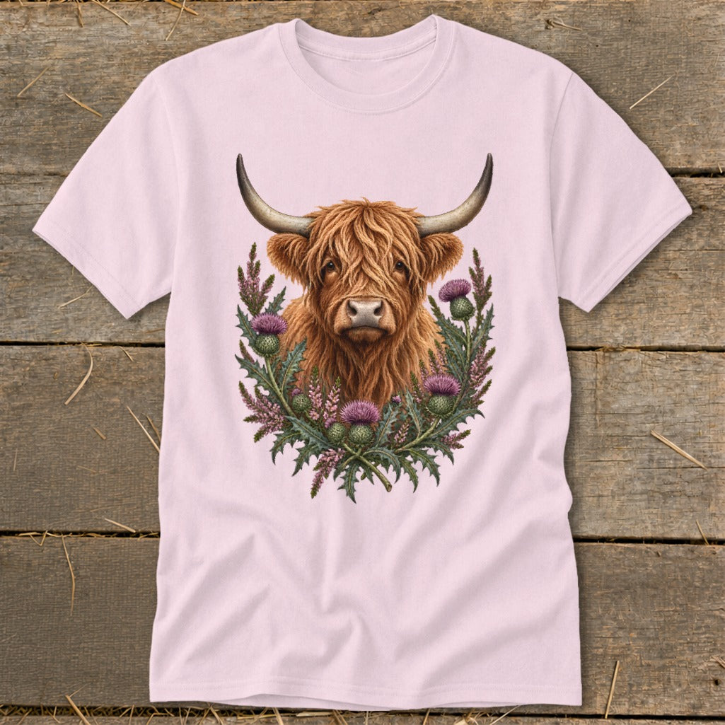Highland cow with thistles design on a pink t-shirt.