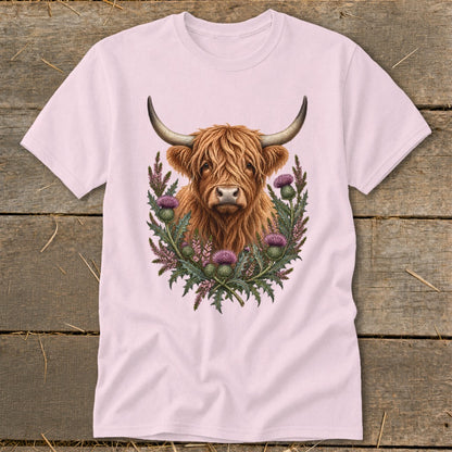 Highland cow with thistles design on a pink t-shirt.