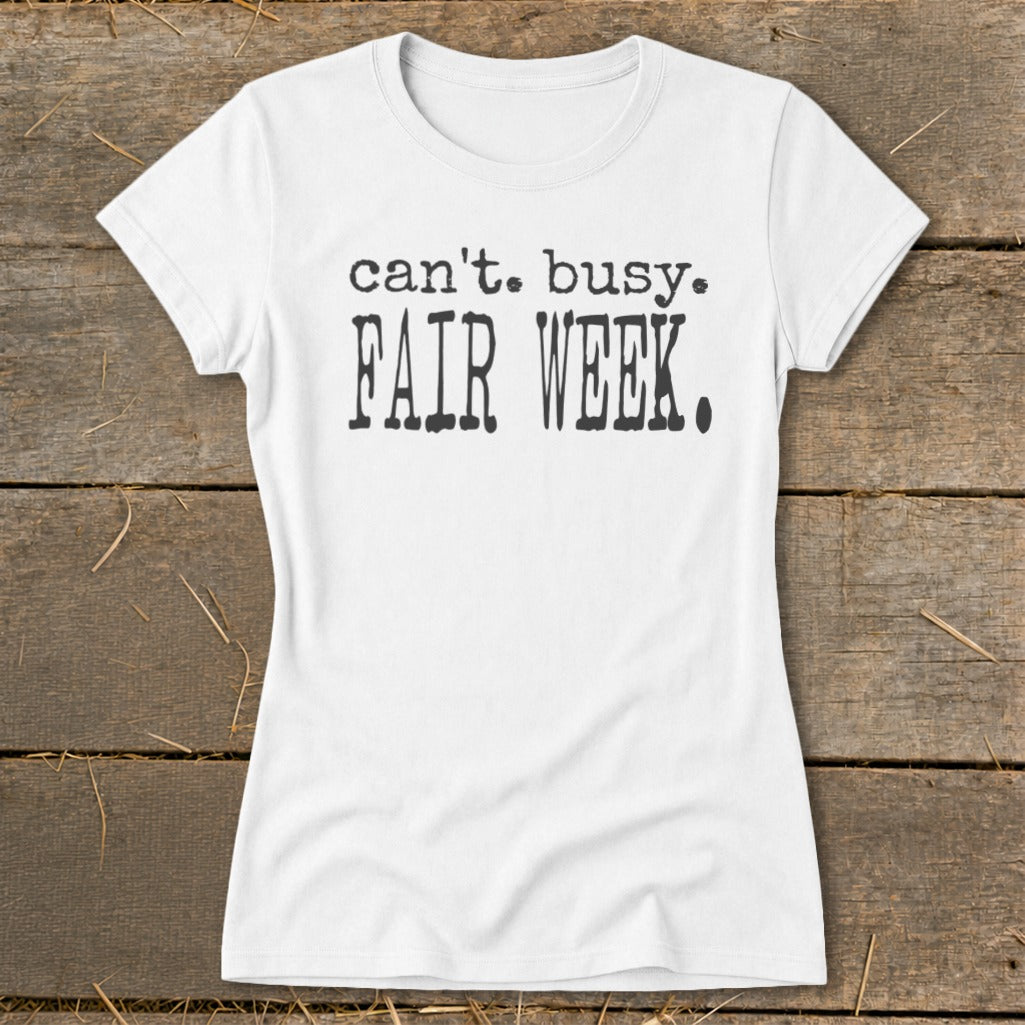 White t-shirt with black text that reads "can't. busy. FAIR WEEK."