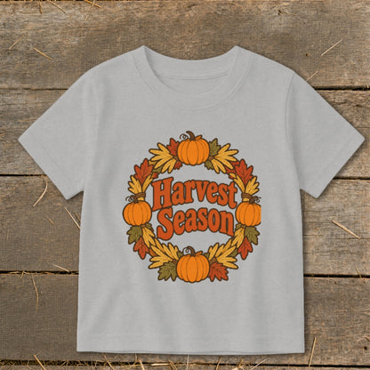 Light grey t-shirt with a circular harvest wreath featuring pumpkins and autumn leaves and the text "Harvest Season".