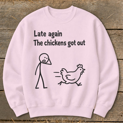 Pink sweatshirt with black text and stick figures: "Late again The chickens got out".