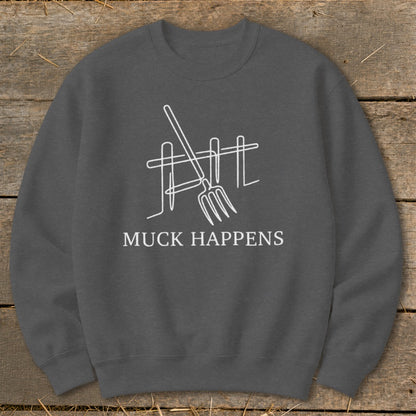 Charcoal sweatshirt with white line art of pitchfork and fence, text "MUCK HAPPENS".