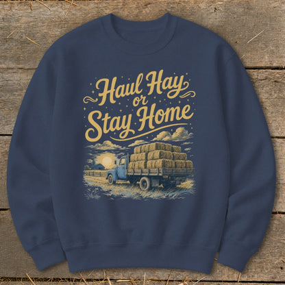 Blue sweatshirt with "Haul Hay or Stay Home" text and a truck loaded with hay bales.