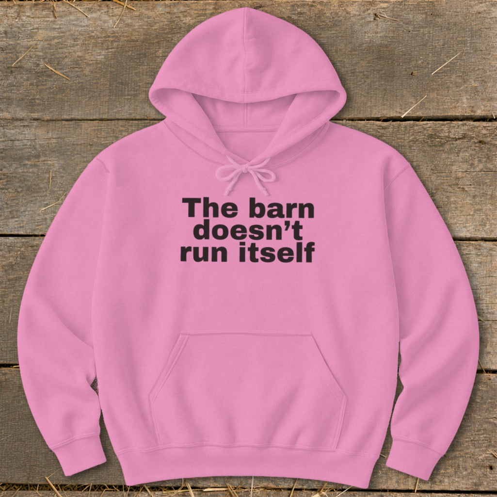Pink hoodie with black text reading "The barn doesn't run itself".