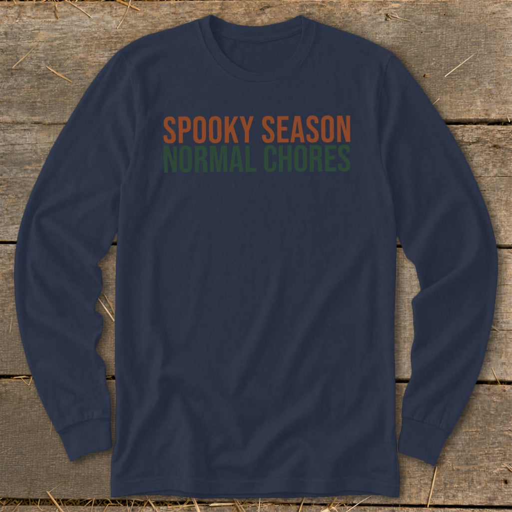 Navy long-sleeve shirt with text "SPOOKY SEASON NORMAL CHORES" in orange and green.