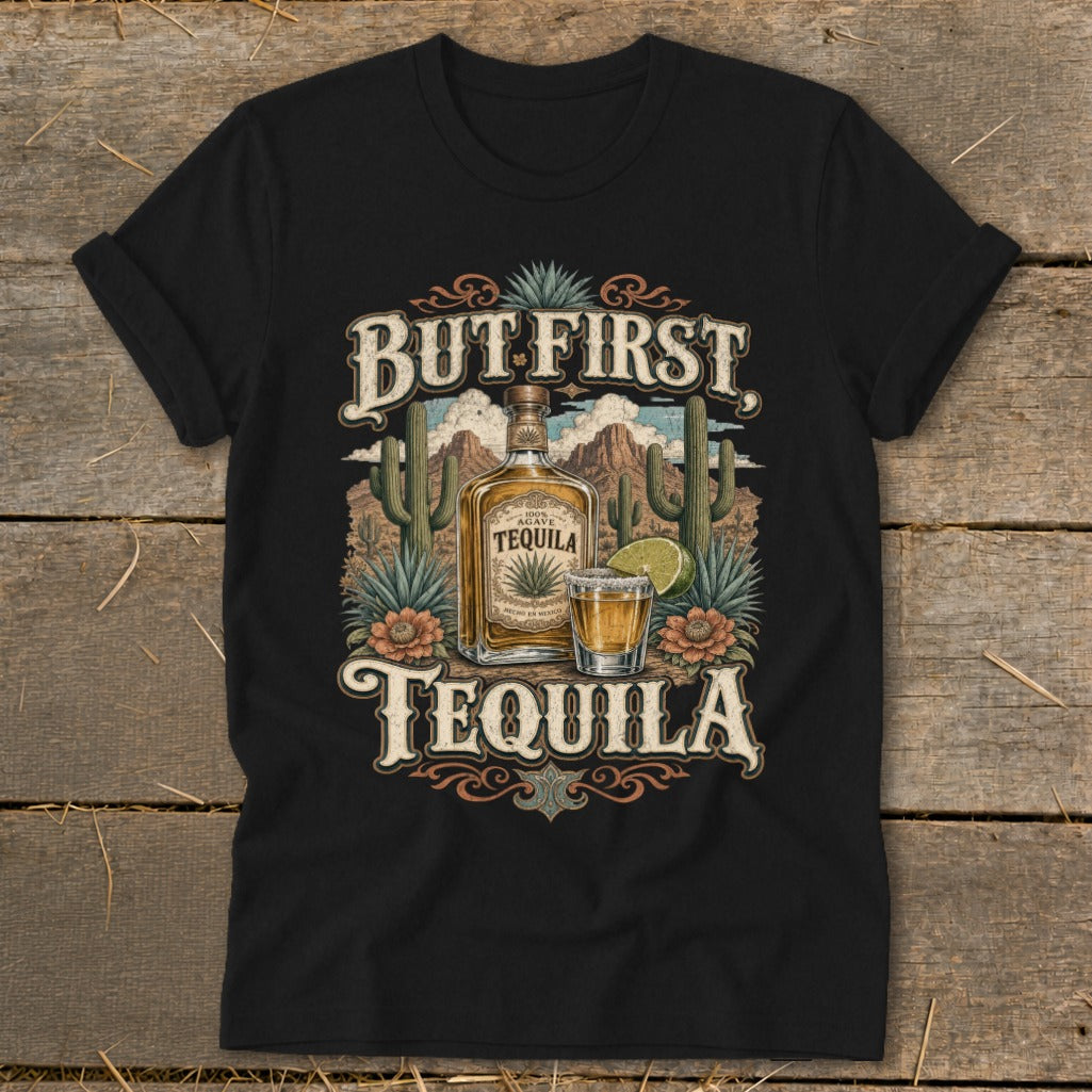 Black t-shirt with "But First Tequila" text, bottle, shot, and desert scene graphic.
