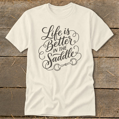 Cream t-shirt with "Life is Better in the Saddle" text and a horse bit graphic.