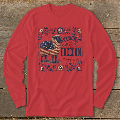 Sheep with American flag wool on red shirt with "Flocks & Freedom Since 1776" text.