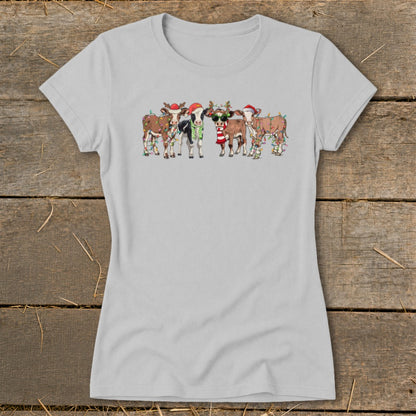 Group of cartoon cows wearing Santa hats and Christmas lights.