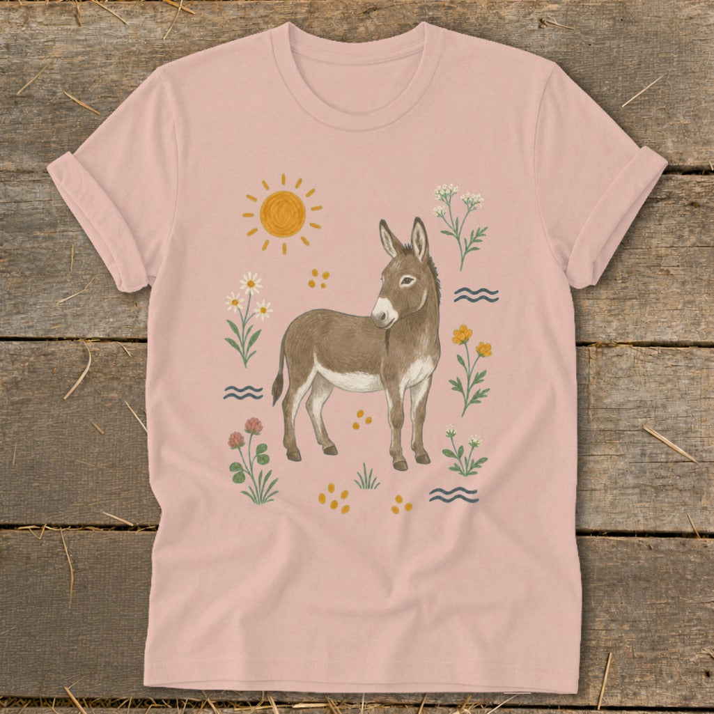 Light pink t-shirt with a watercolor-style donkey surrounded by flowers and sun graphic.