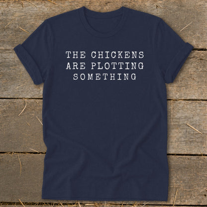 Navy t-shirt with white text: "THE CHICKENS ARE PLOTTING SOMETHING"
