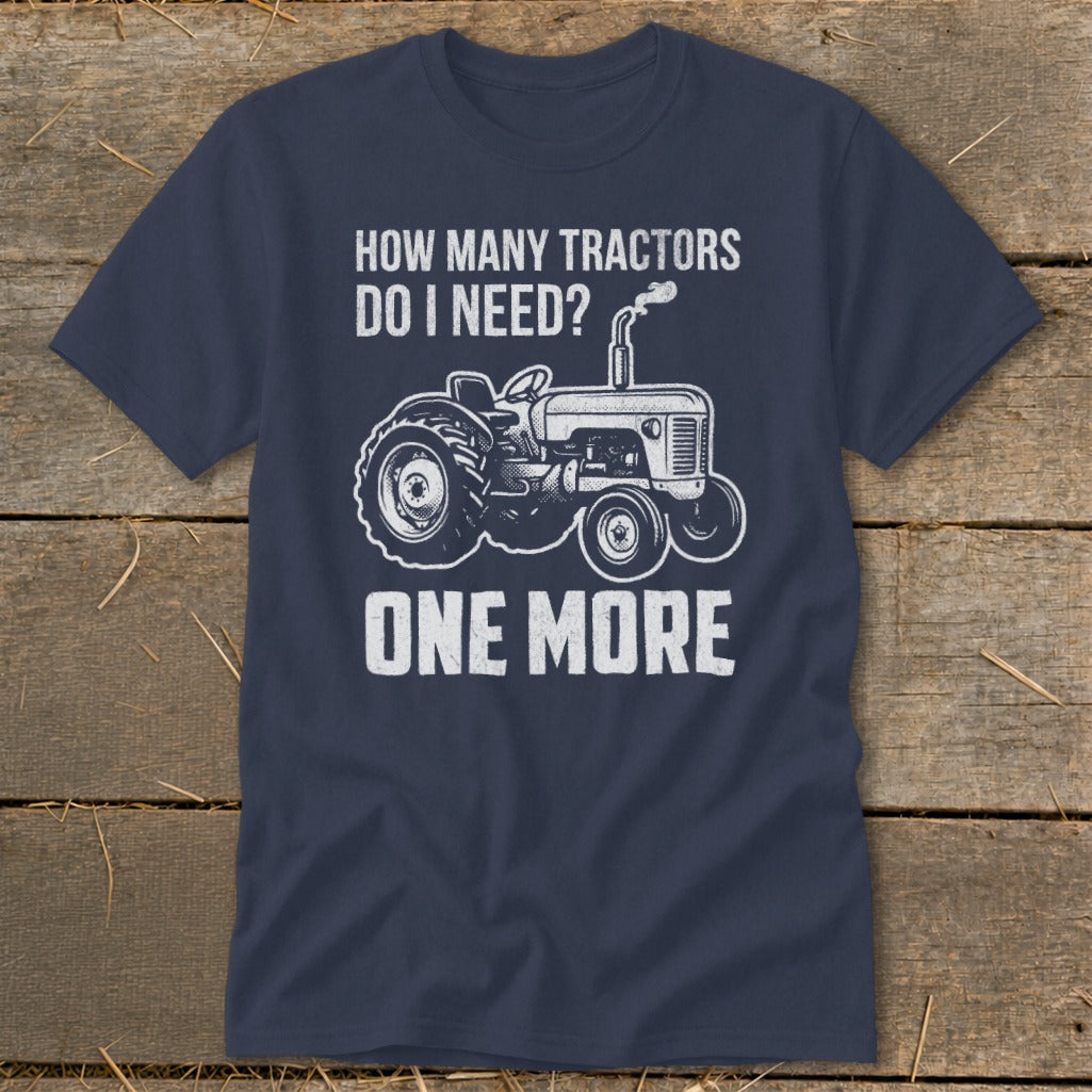 Navy t-shirt with white graphic: "How Many Tractors Do I Need? One More" and a tractor illustration.