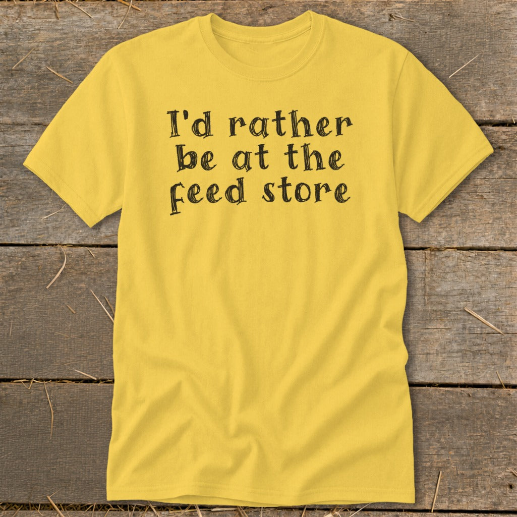 Yellow t-shirt with black text that reads "I'd rather be at the feed store".