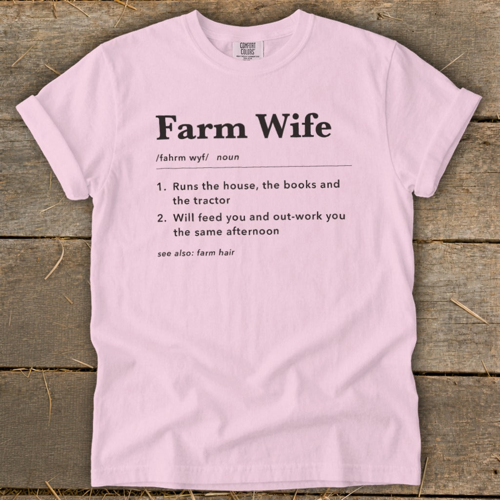 Pink t-shirt with "Farm Wife" definition: "Runs the house, the books and the tractor. Will feed you and out-work you the same afternoon. See also: farm hair."