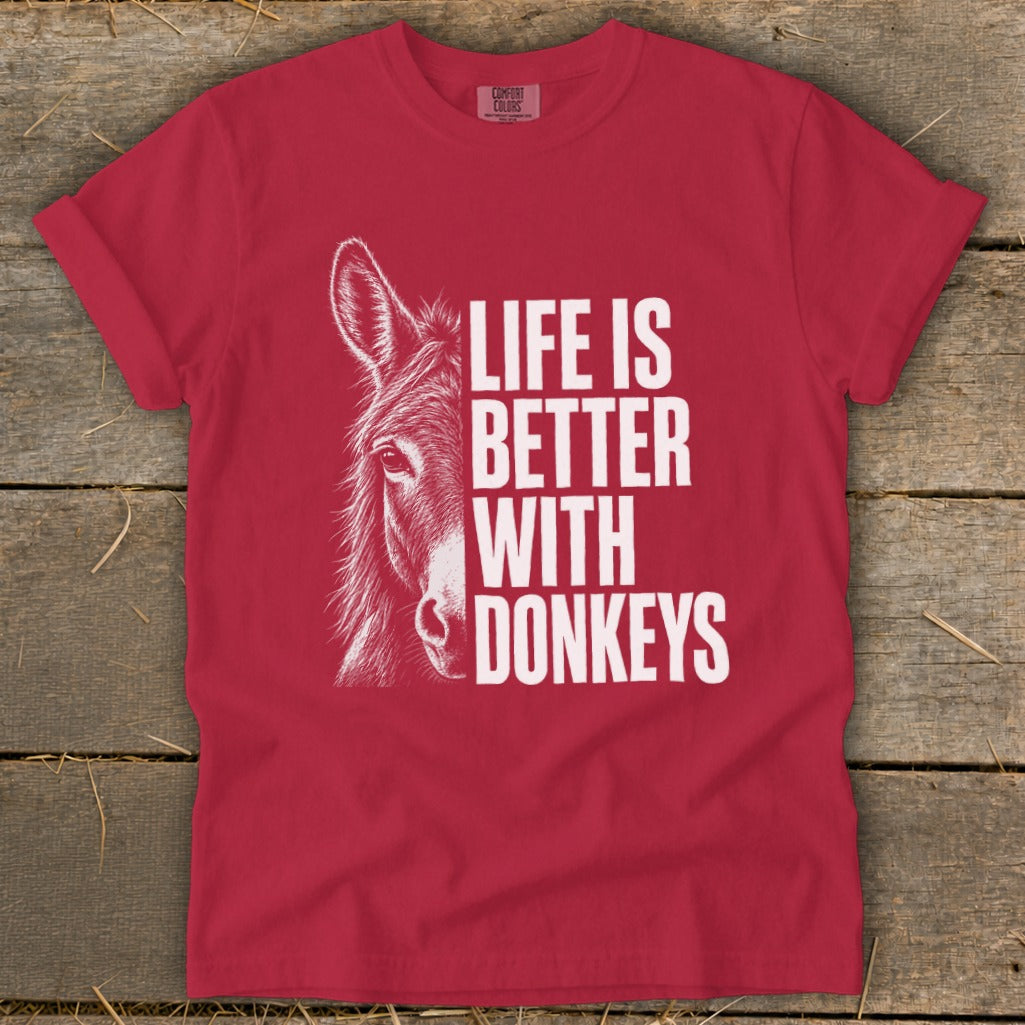 Red t-shirt with a white sketch of a donkey and text that reads "LIFE IS BETTER WITH DONKEYS".