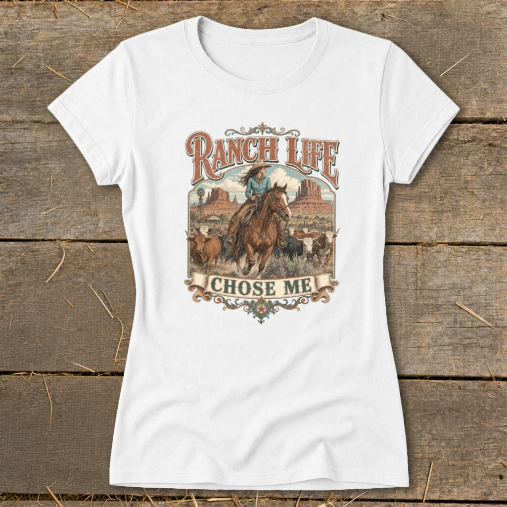 White t-shirt with "Ranch Life Chose Me" graphic featuring a cowboy riding a horse with cattle in a desert landscape.