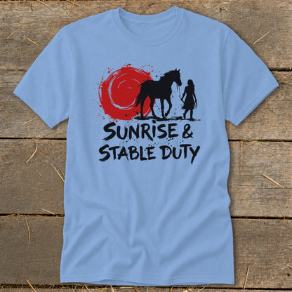Light blue t-shirt with black graphic of horse and person under red sun, text reads "SUNRISE & STABLE DUTY".