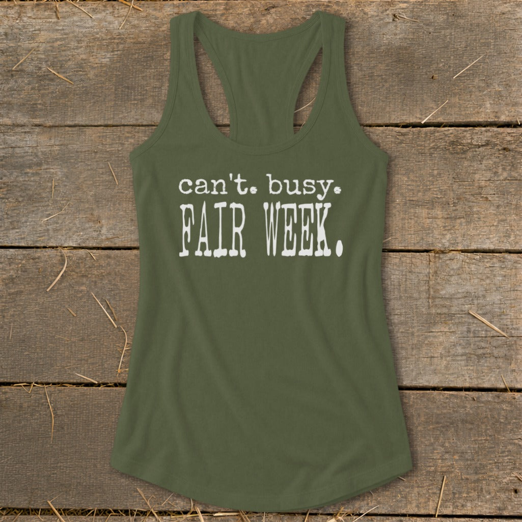 Olive green tank top with white text reading "can't. busy. FAIR WEEK."
