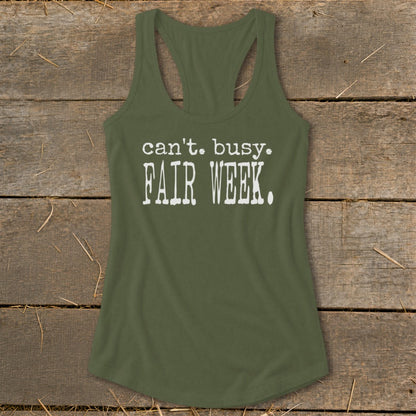 Olive green tank top with white text reading "can't. busy. FAIR WEEK."