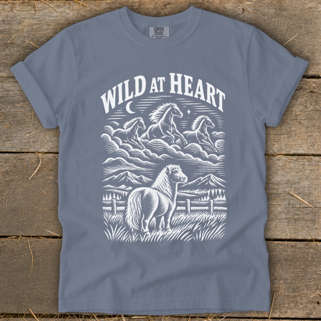 Grey t-shirt with "WILD AT HEART" text and white graphic of horses and mountains.