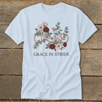 Light blue t-shirt with horse bit, flowers, and text "GRACE IN STRIDE".