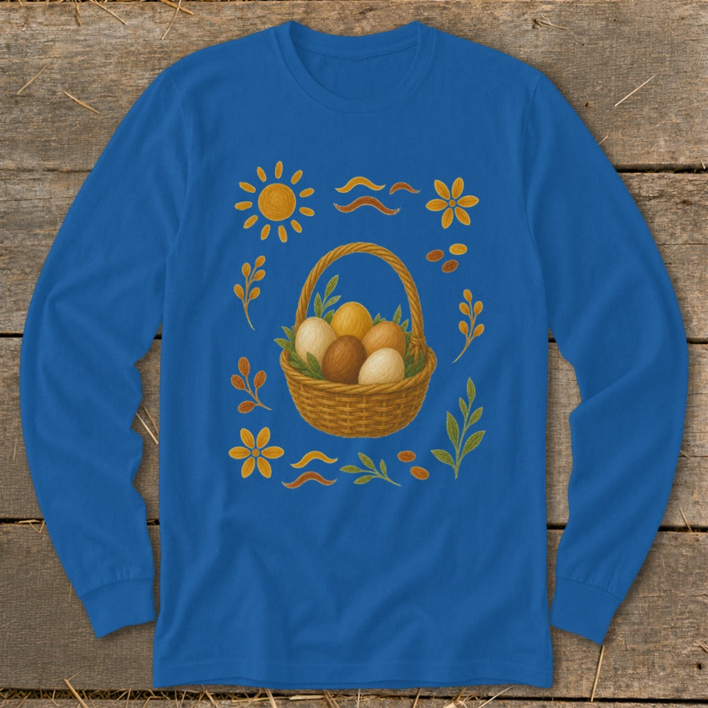 Blue long-sleeve shirt with Easter basket, eggs, sun, and floral decorations.