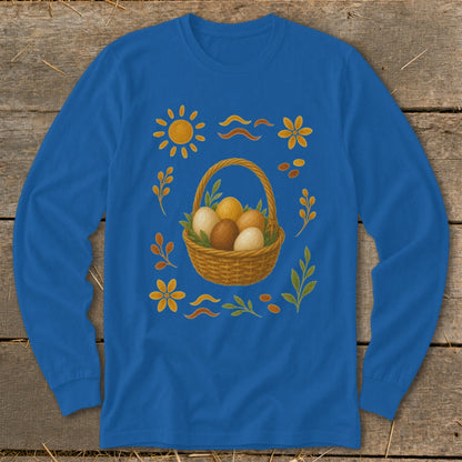 Blue long-sleeve shirt with Easter basket, eggs, sun, and floral decorations.