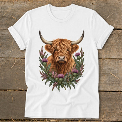 White t-shirt with a Highland cow and thistles graphic print.