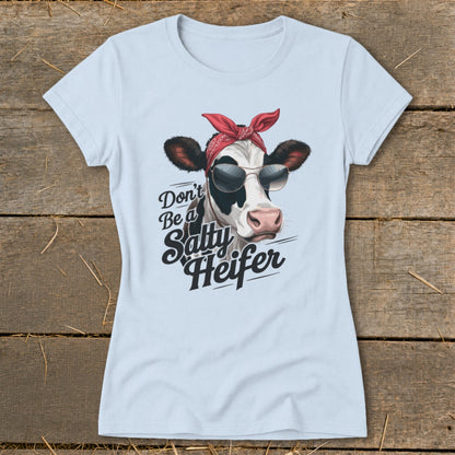 Light blue t-shirt with a cow wearing sunglasses and a bandana, text says "Don't Be a Salty Heifer".