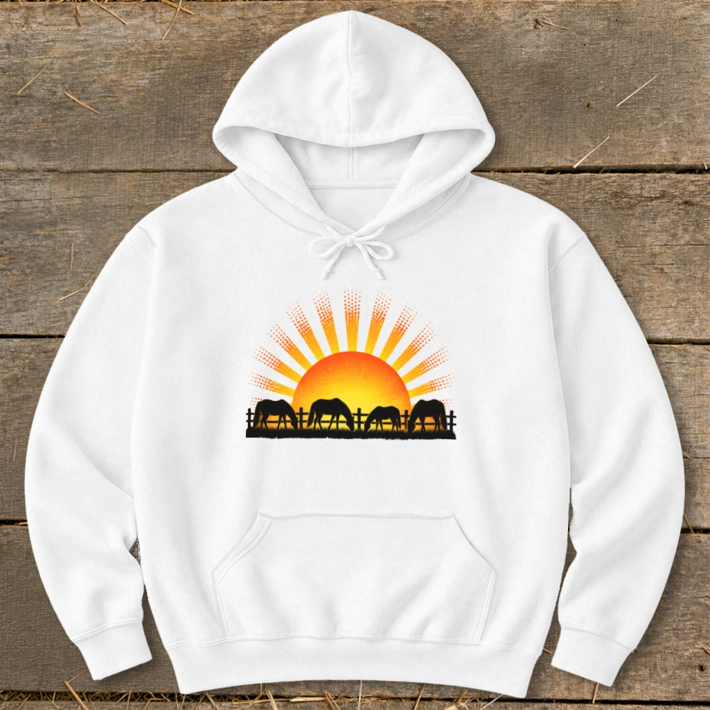 White hoodie with a graphic of horses grazing at sunrise.