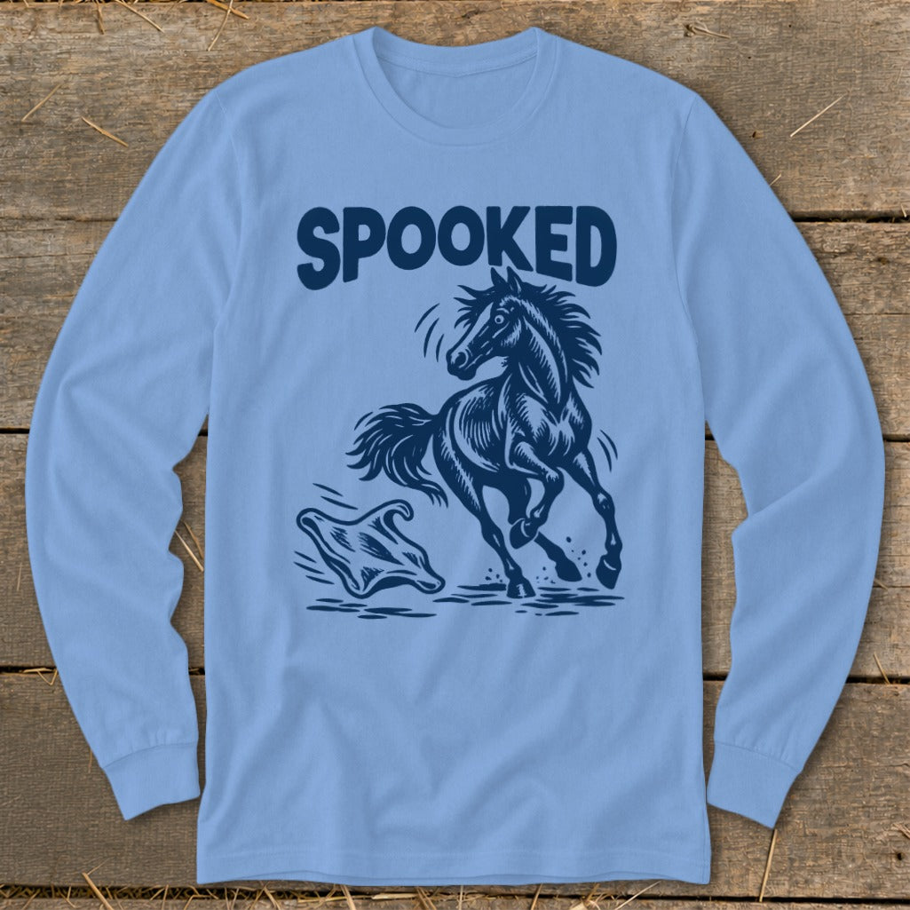 Long sleeve light blue shirt with "SPOOKED" text above a startled horse and a ghost.
