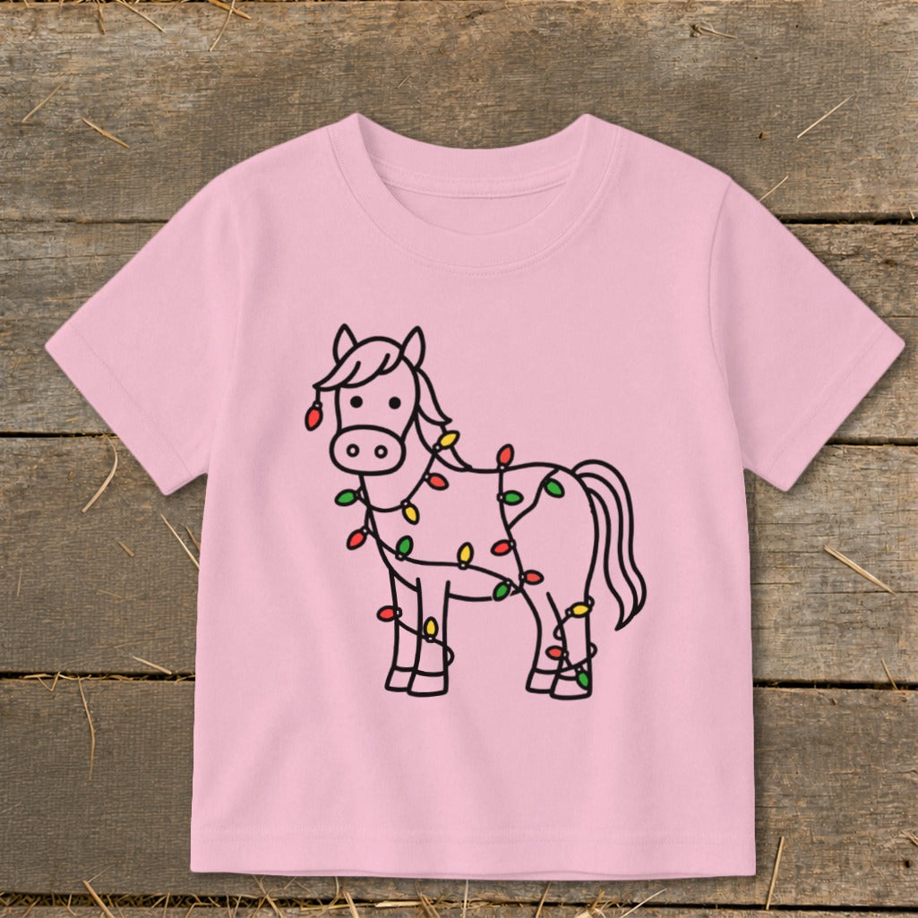 Pink t-shirt with a black outline drawing of a horse wrapped in colorful Christmas lights.