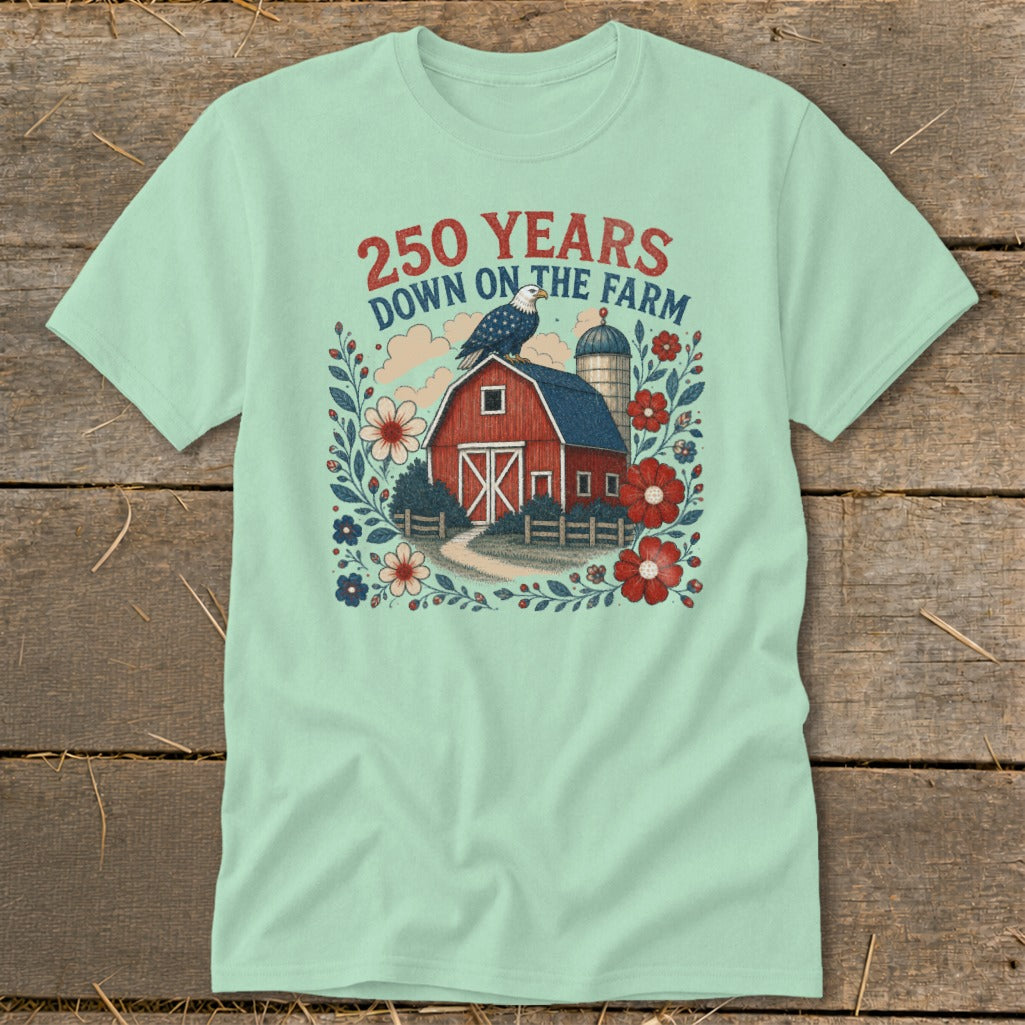 Light green t-shirt with graphic of red barn, eagle, silo, and flowers. Text reads "250 Years Down on the Farm".
