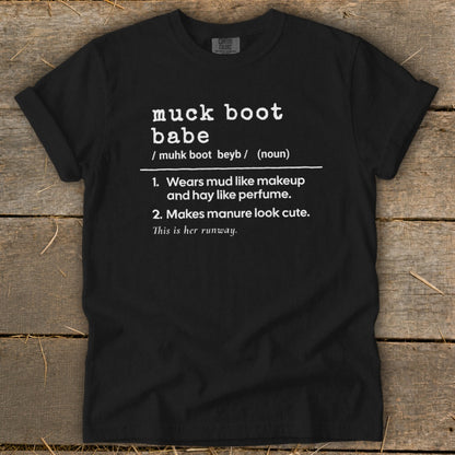 Black t-shirt with white text defining "muck boot babe".
