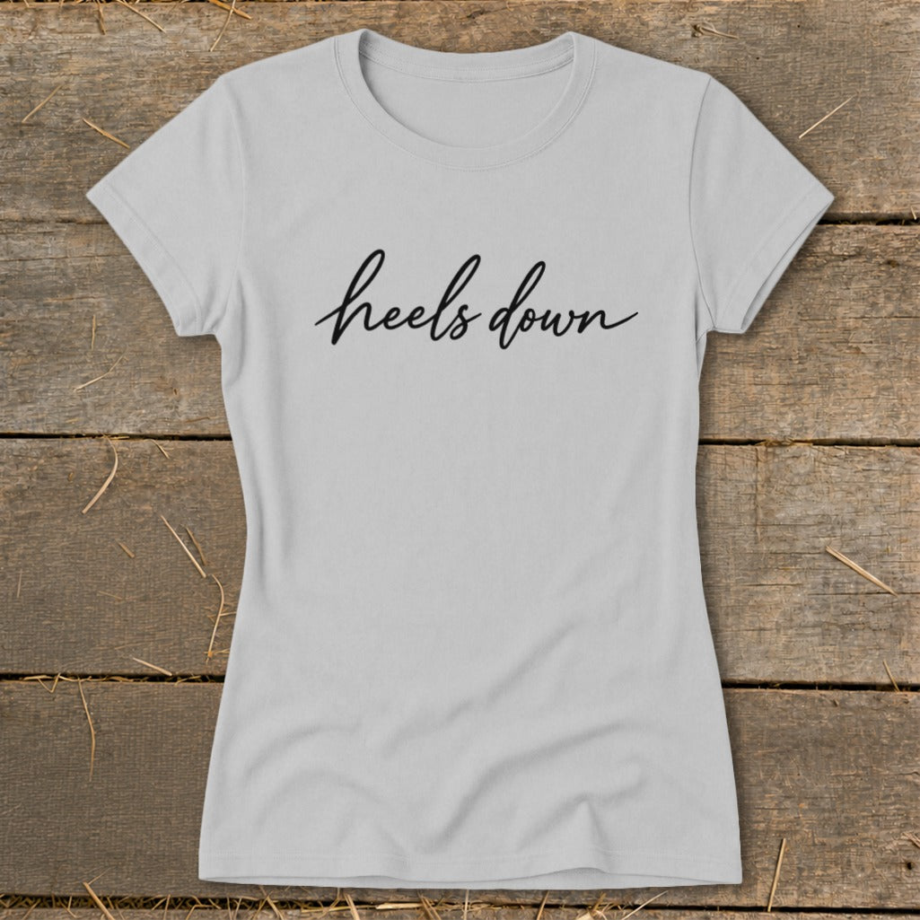 Light grey t-shirt with "heels down" in black script font.