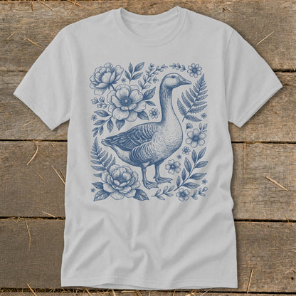 Light gray t-shirt with blue ink drawing of a goose and floral elements.