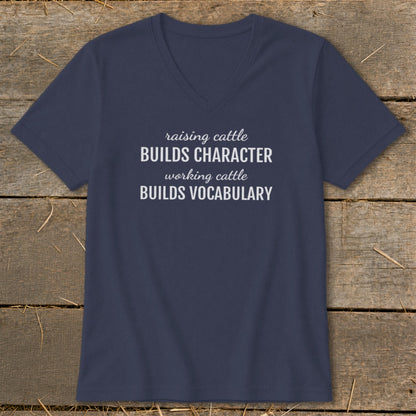 Navy V-neck t-shirt with text: raising cattle BUILDS CHARACTER, working cattle BUILDS VOCABULARY.