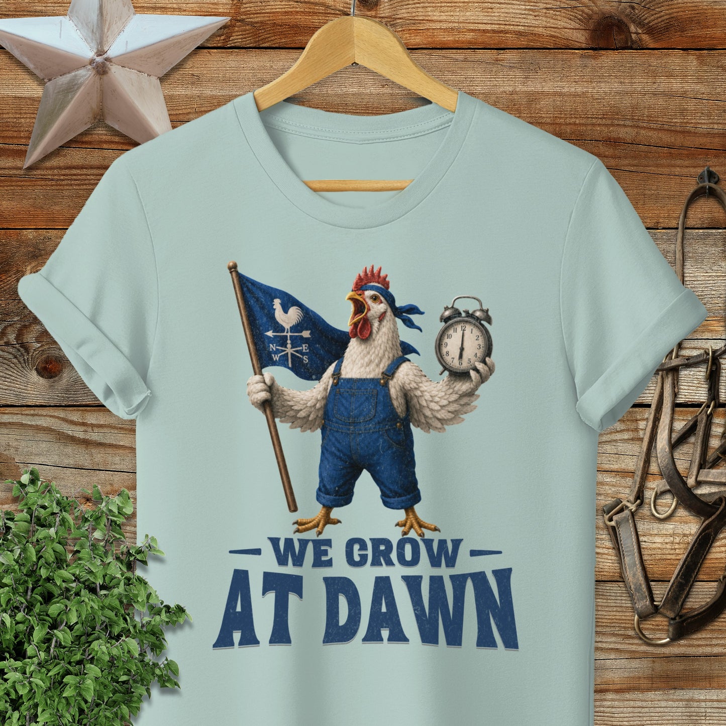 Chicken wearing overalls holds a flag and alarm clock, "We Grow At Dawn" text.