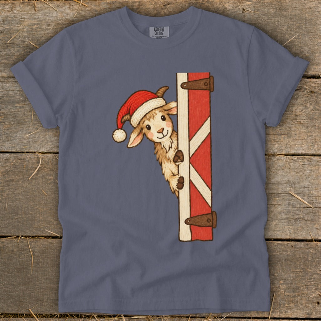Cute llama in a Santa hat peeking around a red barn door.