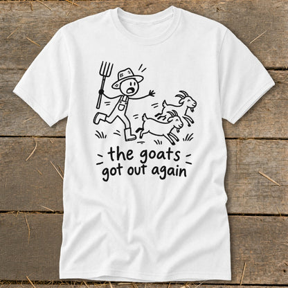 White t-shirt with cartoon farmer chasing three goats, text reads "the goats got out again".