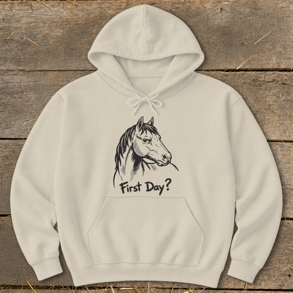 Light beige hoodie with black line drawing of a horse and text "First Day?".