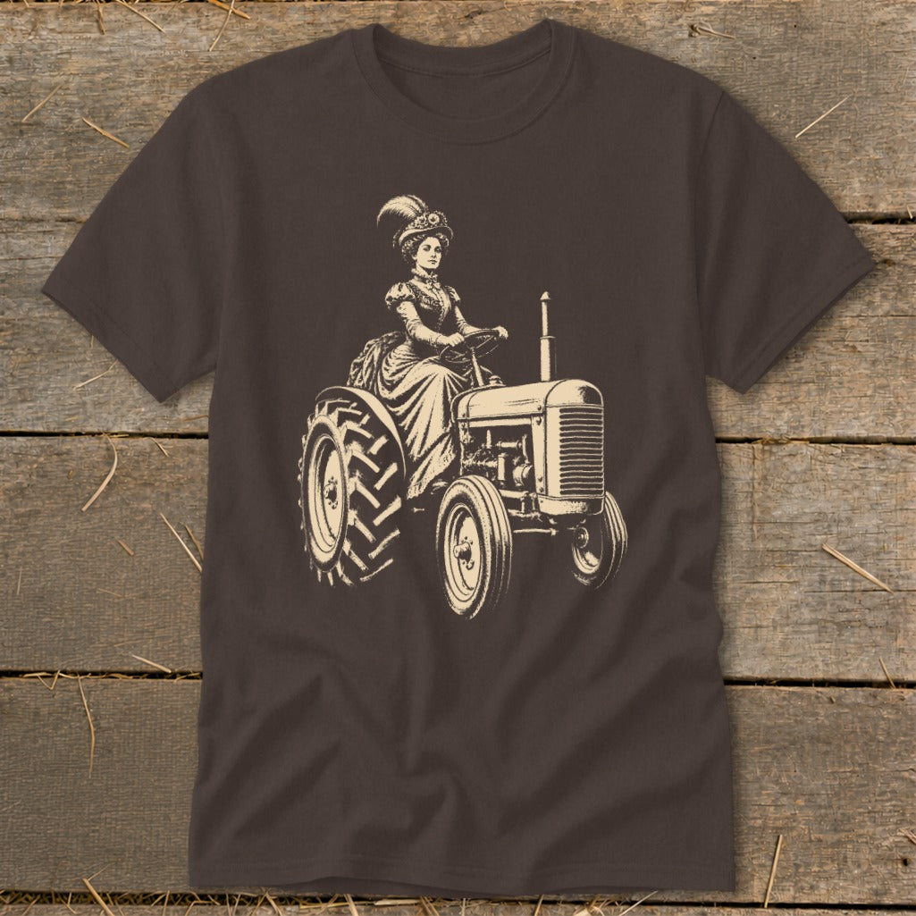 Woman in Victorian dress driving a tractor, illustration on a dark brown t-shirt.
