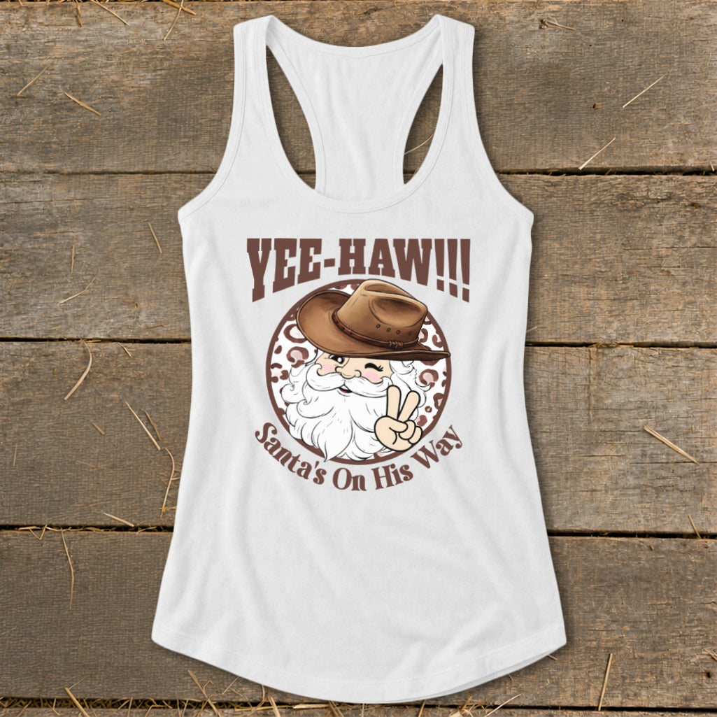 White tank top with Santa wearing a cowboy hat and the text "Yee-Haw!!!" and "Santa's On His Way."